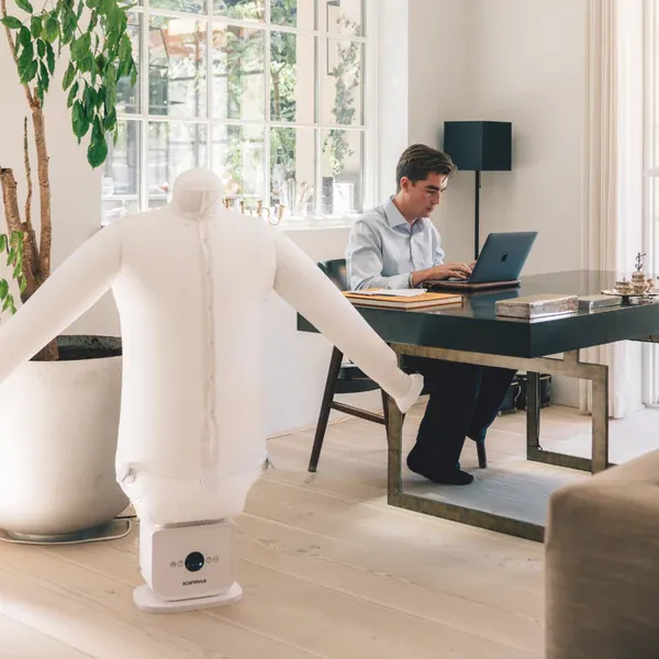 Shirt drying on an automatic ironing machine in a bright home office